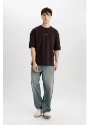 Defacto تي شيرت فضفاض مناسب برقبة دائرية وأكمام قصيرة من القماش الثقيل C0896ax24sp