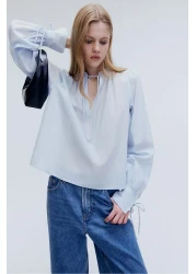 H&M بلوزة قطنية بتفاصيل ربطة عنق