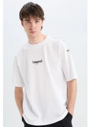 Defacto تي شيرت قطن 100% كبير الحجم بقصة واسعة وياقة دائرية وطباعة خلفية وأكمام قصيرة D5600ax25sp