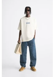 The Champ Clothing تي شيرت رجالي أبيض كبير الحجم مطبوع عليه سجلات Peanuts برقبة دائرية