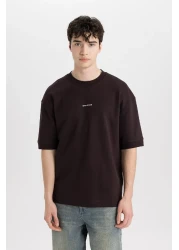 Defacto تي شيرت فضفاض مناسب برقبة دائرية وأكمام قصيرة من القماش الثقيل C0896ax24sp