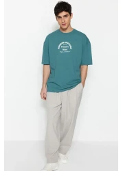  Collection تي شيرت قطني سميك كبير الحجم/قصة واسعة ورقبة دائرية وأكمام قصيرة مطبوع عليه نص TMNSS23TS00083