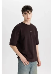 Defacto تي شيرت فضفاض مناسب برقبة دائرية وأكمام قصيرة من القماش الثقيل C0896ax24sp