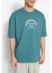  Collection تي شيرت قطني سميك كبير الحجم/قصة واسعة ورقبة دائرية وأكمام قصيرة مطبوع عليه نص TMNSS23TS00083